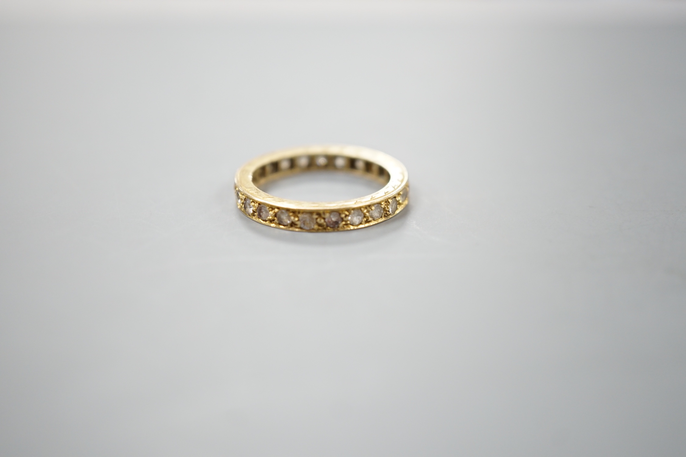 An 18ct and diamond chip set full eternity ring, size L, gross weight 3.4 grams.